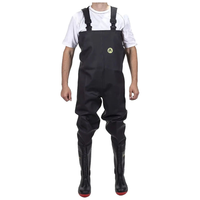A person is wearing black waterproof waders with straps and red soles while standing upright. The background is plain, emphasizing the attire designed for wet environments.