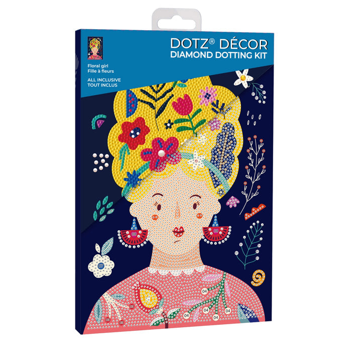 The Diamond Dotz Large Dotz Decor kit box shows an illustrated woman with yellow hair, red earrings, and a pink top, decorated with colorful flowers and floral patterns on a dark blue background.