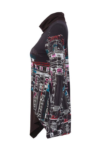 Dotique Dolcezza 76642 assorted cityscape print knit jumper with a roll neckline and asymmetric draped hem.