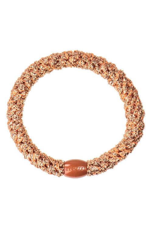 KKNEKKI Rosegold glitter elastic hair tie with shimmering rosegold fibers and a matching branded clasp by KKNEKKI. Shop KKNEKKI at Dotique.
