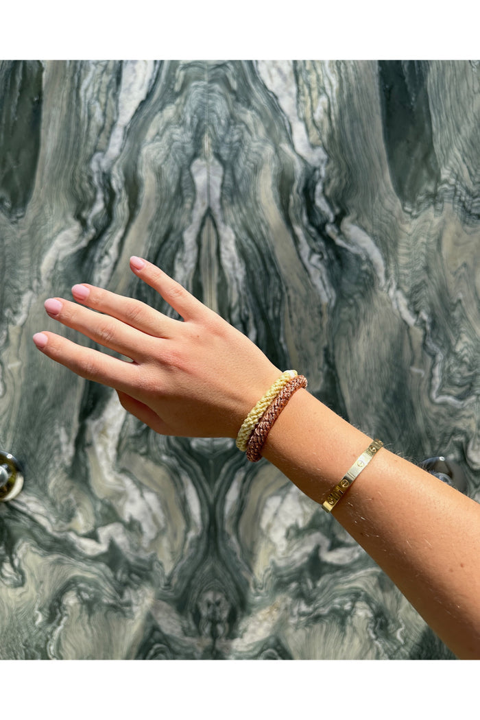 KKNEKKI Rosegold glitter elastic hair ties in warm tones worn on wrist with gold bracelet, styled against a marbled background, shop KKNEKKI at Dotique.