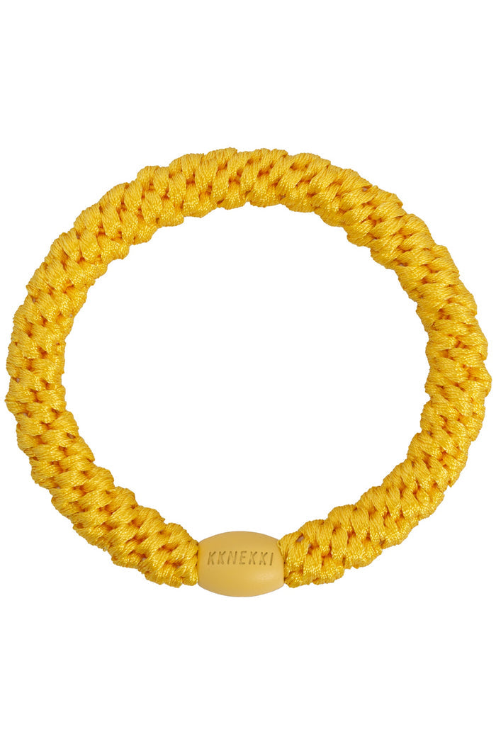 KKNEKKI Sun yellow braided elastic hair tie with a smooth branded clasp by KKNEKKI. Shop KKNEKKI at Dotique.