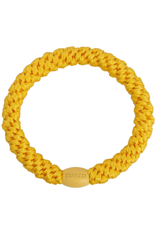 KKNEKKI Sun yellow braided elastic hair tie with a smooth branded clasp by KKNEKKI. Shop KKNEKKI at Dotique.