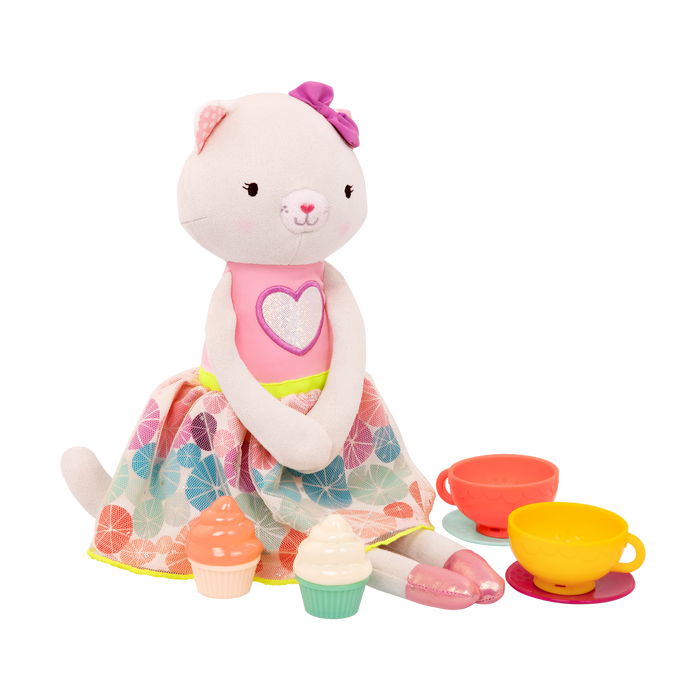 Tea set with plush cat and book.