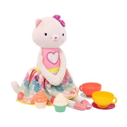 Tea set with plush cat and book.