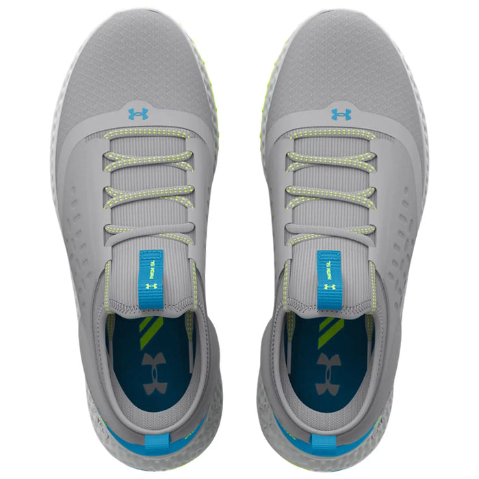 Gray athletic shoes are positioned on a flat surface laces are threaded through eyelets and the tongue features a blue tab with branding the interior shows contrasting colors and logo.